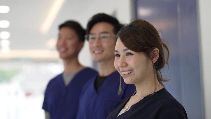 亚洲华人医生护士微笑着望向别处