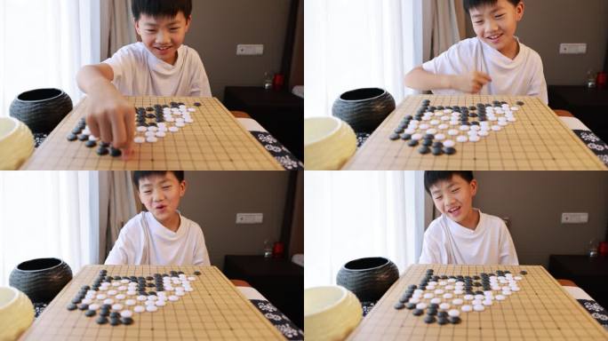 可爱的男孩在窗边下围棋慢镜