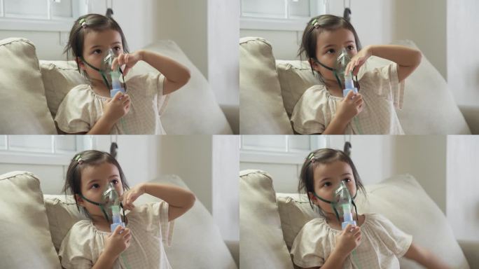 患病的亚洲女孩接受雾化器吸入治疗