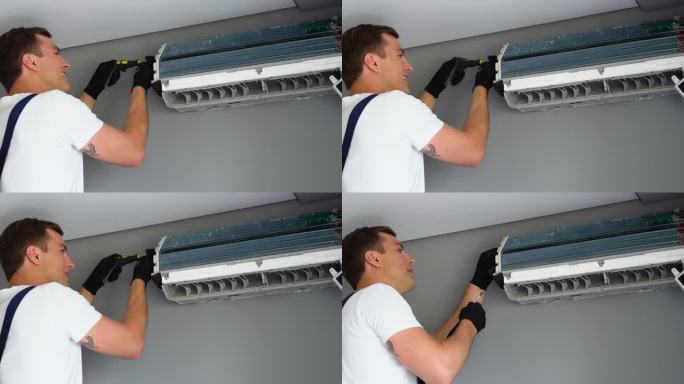 专业技术人员在室内安装或维护现代空调