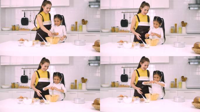 母亲和女儿在厨房里一起烤面包