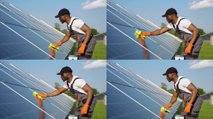 非裔美国技术人员正在清洁太阳能电池板