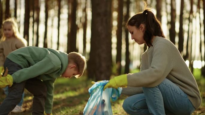 森林中的垃圾污染，捡拾塑料垃圾的志愿者，少年和他的母亲