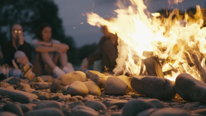 当家人和朋友围坐在火堆旁共度时光，保持着特殊的联系，并通过火来充电，这段视频传达了能量和快乐的生活。