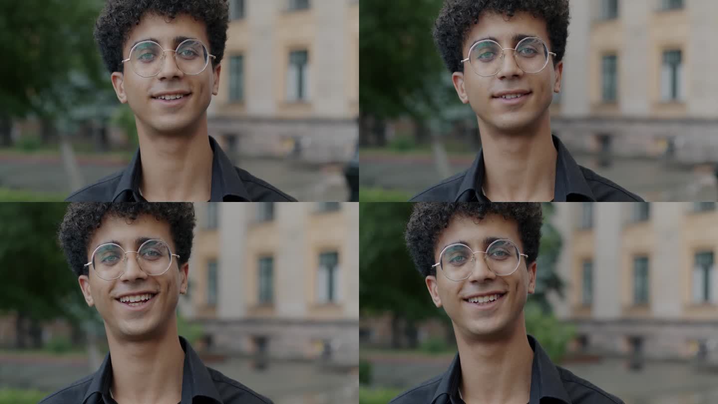 一名戴眼镜的中东男子在城市户外微笑的慢动作肖像