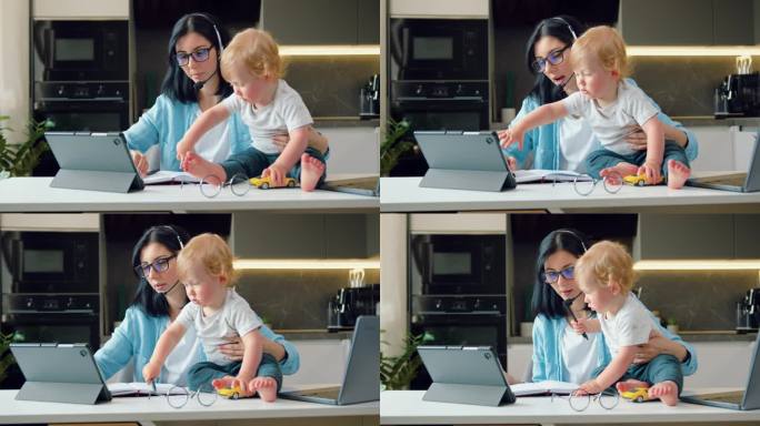 一位年轻的母亲兼企业首席执行官在厨房餐桌上摆弄着笔记本电脑，而她的孩子却在玩耍，心烦意乱。做母亲的同