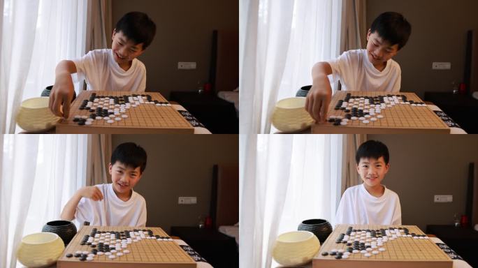 可爱的男孩在窗边下围棋慢镜