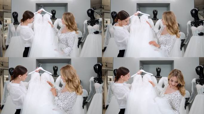 女店员在婚庆店咨询年轻新娘的前视图。顾问女孩向准新娘展示婚纱