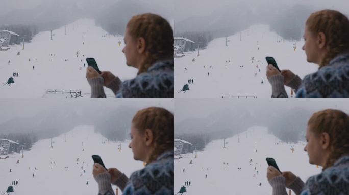 一名女子在滑雪道上使用手机