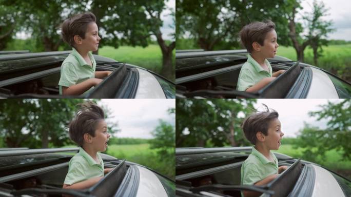 有趣快乐的小男孩站在开放的汽车天窗在旅行，夏天。童年
