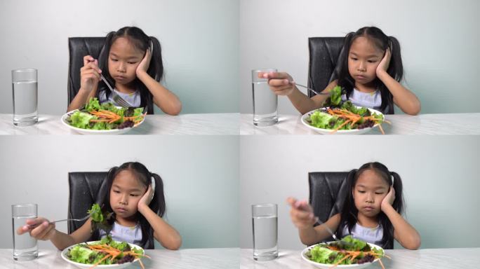 可爱的小女孩拒绝吃健康的蔬菜。