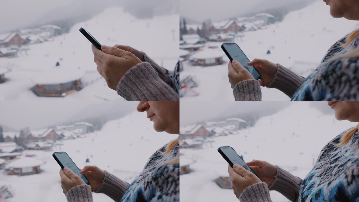 一位女士在滑雪道上使用她的智能手机
