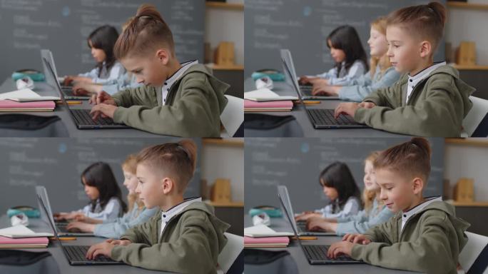 三个小学生用笔记本电脑做作业