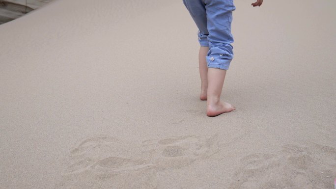 儿童在沙子上行走