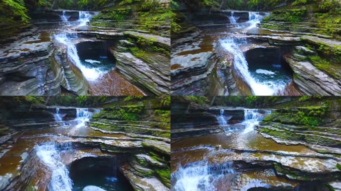 慢航拍瀑布的细节旁边的岩石峡谷与层