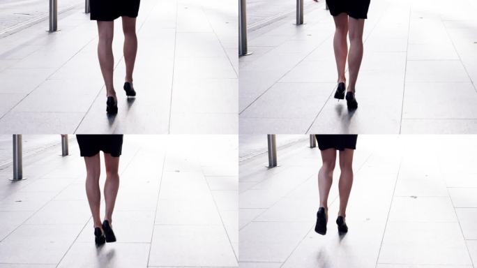 性感的腿黑色高跟鞋走在城市街道