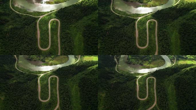 空中无人机拍摄的蜿蜒穿过森林的山路