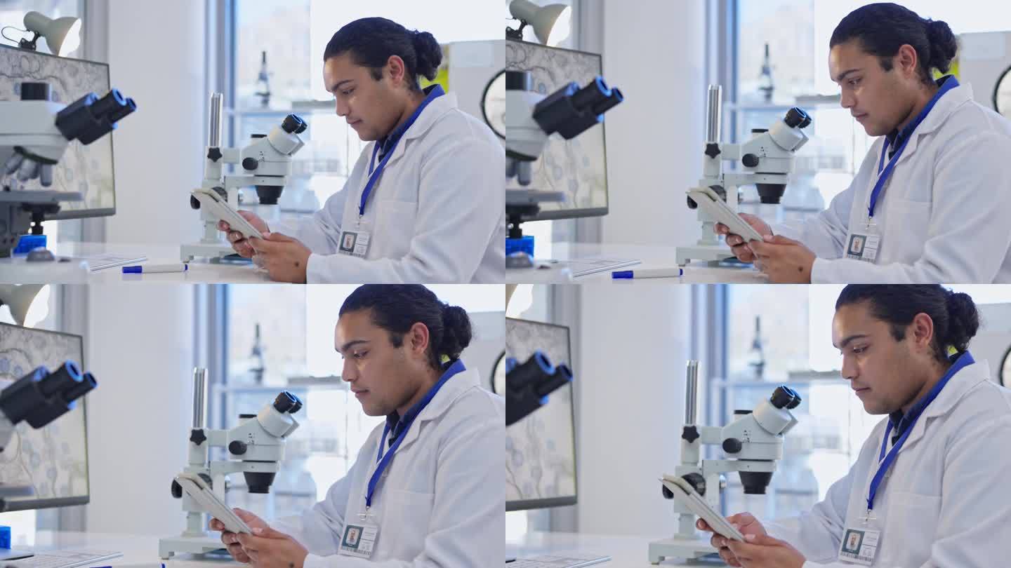 数码平板电脑，显微镜和实验室里的科学家在互联网上做药物研究。在实验室使用移动设备的技术、科学和专业男