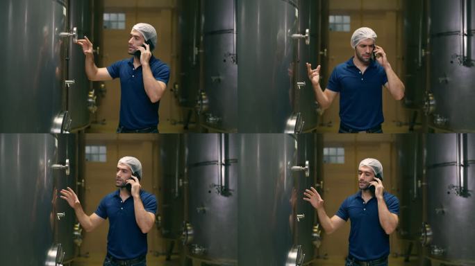 4K白种人酿酒师在酒窖里用手机通话。