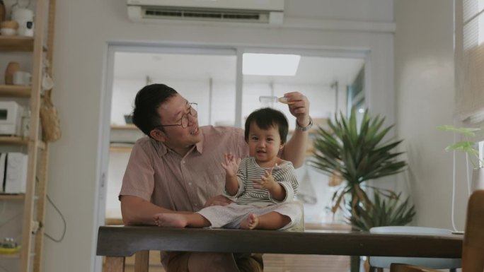 快乐的泰国家庭，单身父亲用爱照顾他的女婴。