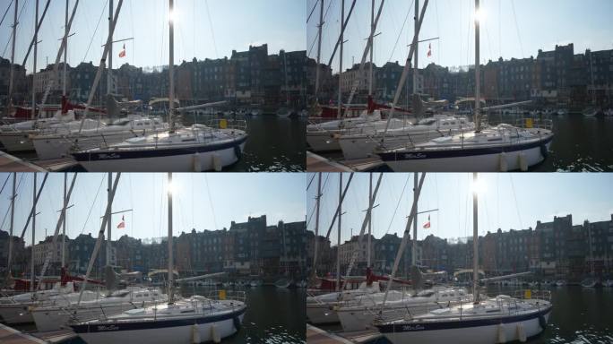 法国翁弗勒尔- 2023年5月3日。在法国诺曼底翁弗勒尔的翁弗勒尔港或旧港口的帆船，在阳光的背景下