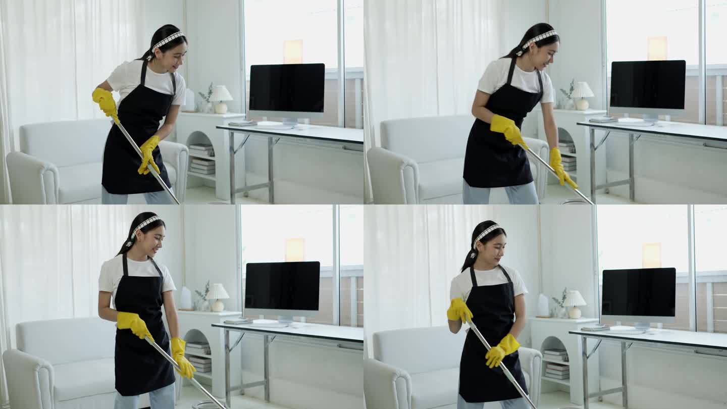 一个打扫房子的女人的特写镜头。她一边打扫桌子，一边用喷雾器和蓝色布擦灰尘。房屋清洁概念。