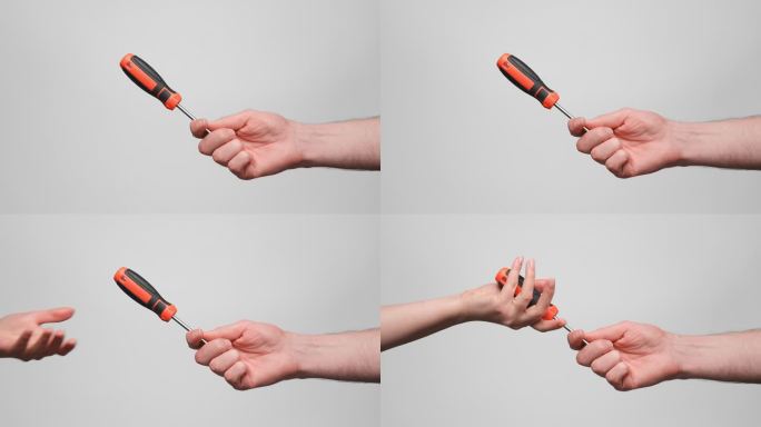 一个男人把黑橙相间的螺丝刀送给一个女人。特写，慢镜头，4k。