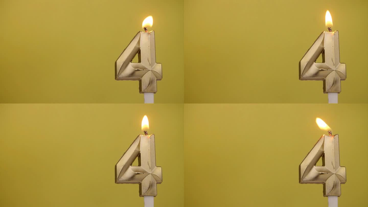 燃烧的生日蜡烛在黄色。数字4。文本的复制空间。