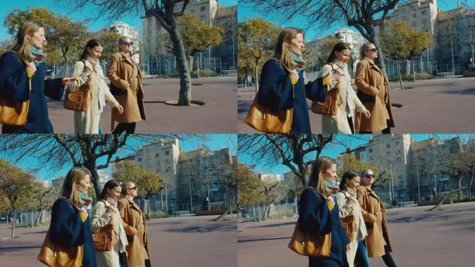 在巴塞罗那，三个女性朋友一边走在人行道上一边聊天