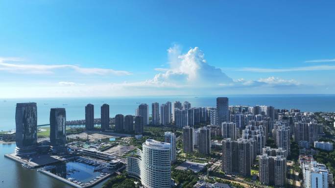 航拍夏季蓝天白云下的海南海口滨海城市风光