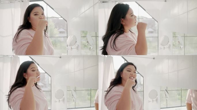 可爱的亚洲女人把牙膏涂在牙刷上，在家里的浴室里刷牙。成年女性在牙刷上涂抹修复膏，呵护牙龈健康，预防龋