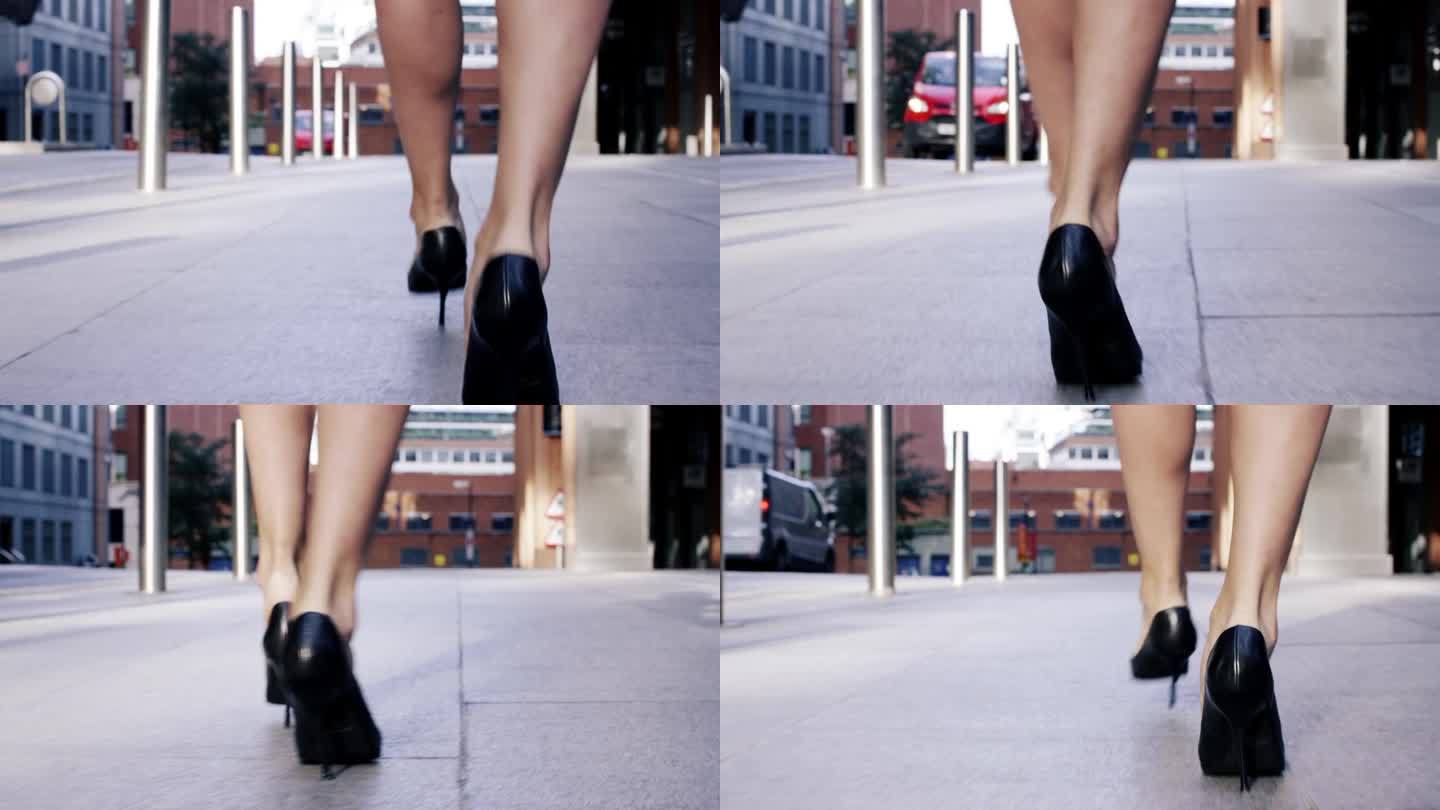 性感的腿黑色高跟鞋走在城市街道