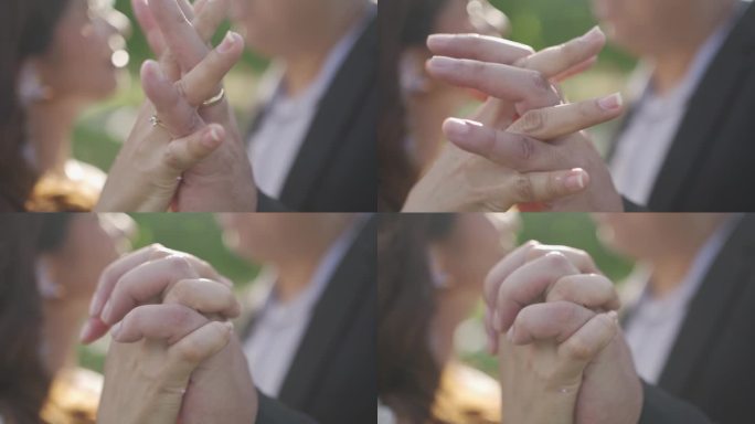 新郎和新娘手握结婚戒指的特写慢动作镜头