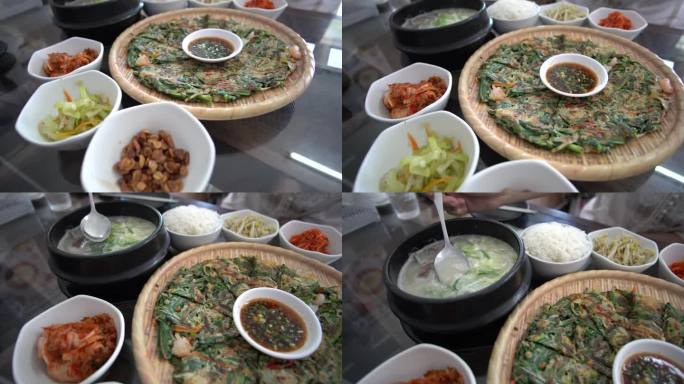 手吃韩牛牛骨汤全韩式传统料理煎饼和配菜动作拍摄4k