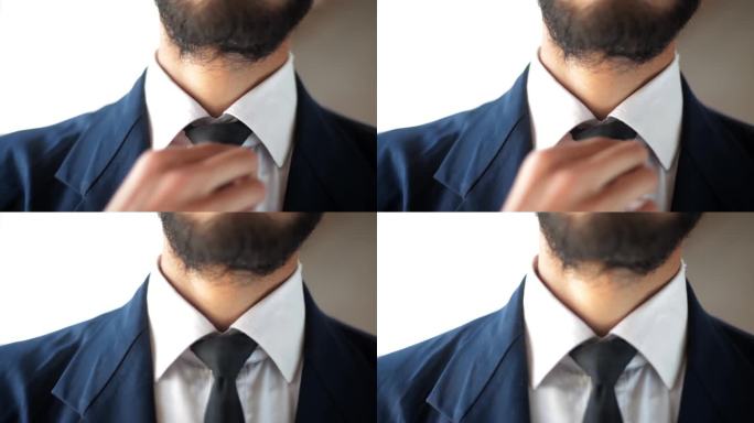 一个商人调整领带的特写镜头，一个人在办公室放松领带。男人忙了一天整理领带，累了。