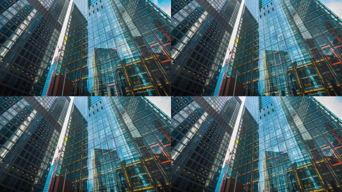 低角度拍摄的高层企业大楼，高层间云层反射的摩天大楼，大楼中心的玻璃电梯
