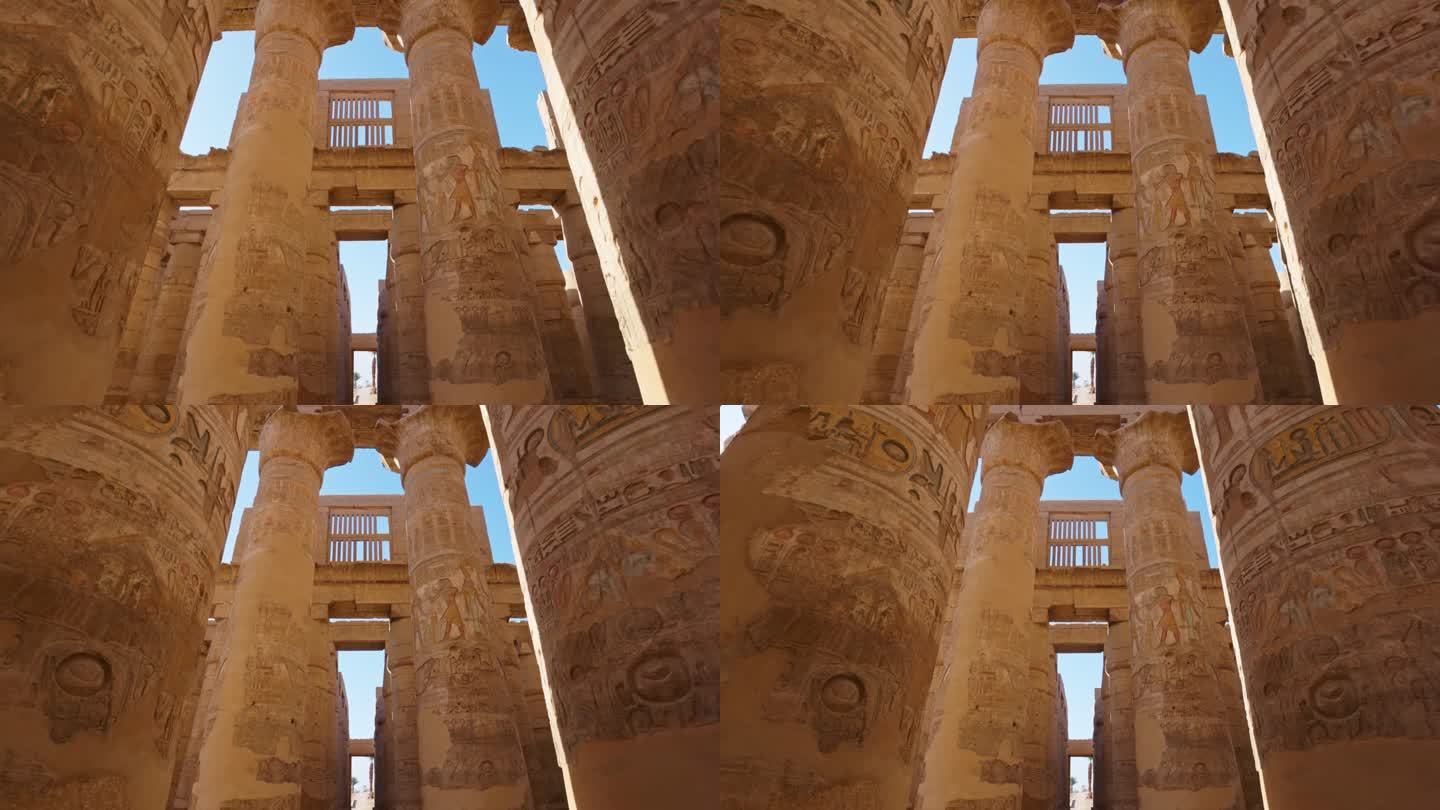 埃及卢克索的卡纳克神庙。摄像机在带有古埃及绘画的雄伟圆柱之间移动。万向节高质量拍摄