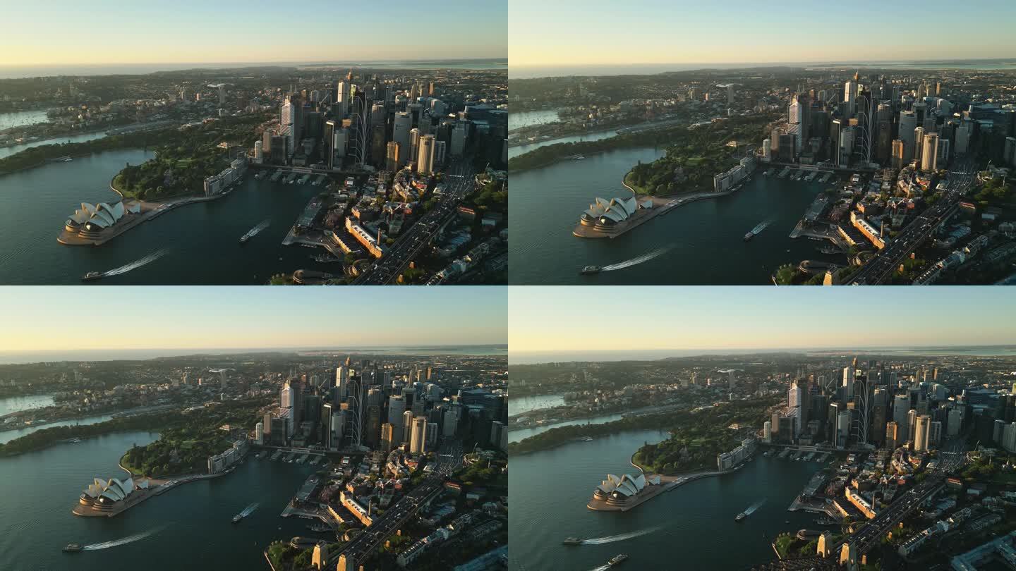 日出时悉尼中央商务区上空的4K鸟瞰图，海港大桥，各种现代办公大楼和歌剧院