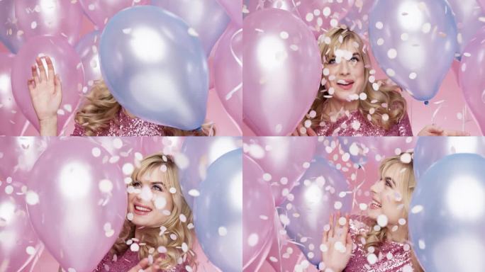 美丽的年轻女子跳舞庆祝生日聚会粉红色和蓝色气球背景-红色史诗龙