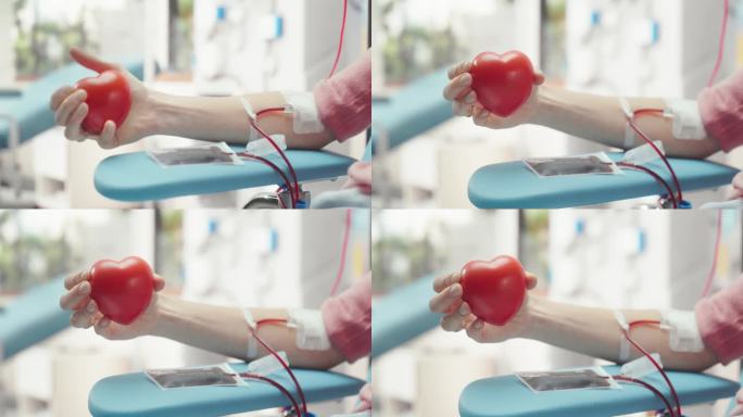 附置导管的女性献血者手部特写。白人妇女挤压心形红球，将血液通过管道泵入袋子，并向镜头展示，作为支持的