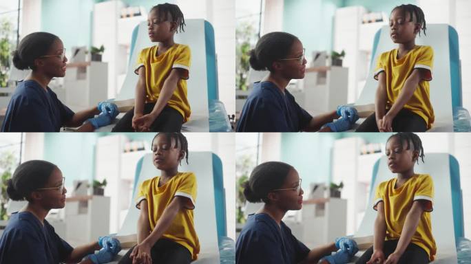 非洲男孩坐在医院的椅子上，和黑人女护士说话。职业女性倾听年轻人的症状并给出适当的治疗建议。公共医疗理