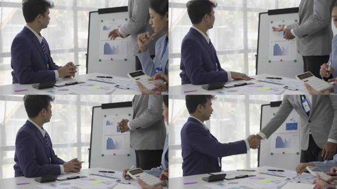 亚洲商人在公司办公室的常务会议上握手，男女握手祝贺成功，金融经营理念