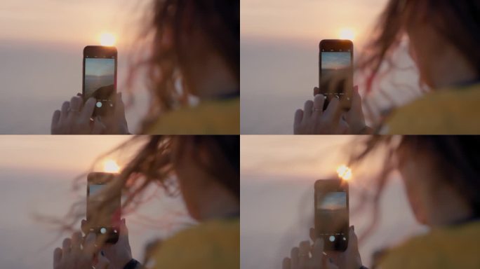 用智能手机拍摄日落的女人女孩拍照，头发吹过海景，柔和的光线镜头光晕景观自然背景，享受假期旅行冒险