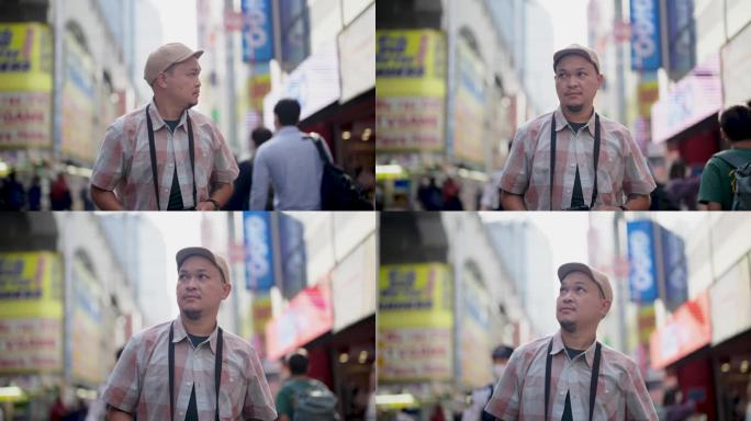 亚洲男性游客在东京市内观光、散步、观光，并享受拍照。