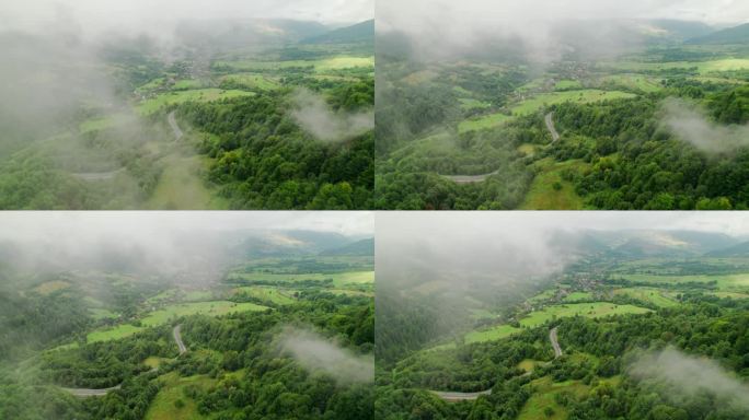 无人机航拍的山路蜿蜒穿过森林，穿过云层