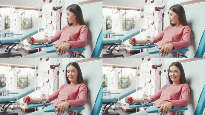 白人妇女在医院为有需要的人献血。女献血者挤压心形球泵血。对着镜头微笑。事故受害者捐赠中心。