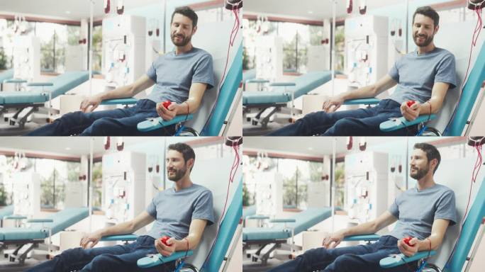 白人男子在光明医院为有需要的人献血。男性献血者挤压心形红球，将血液通过管道泵入袋中。为烧伤病人捐款。