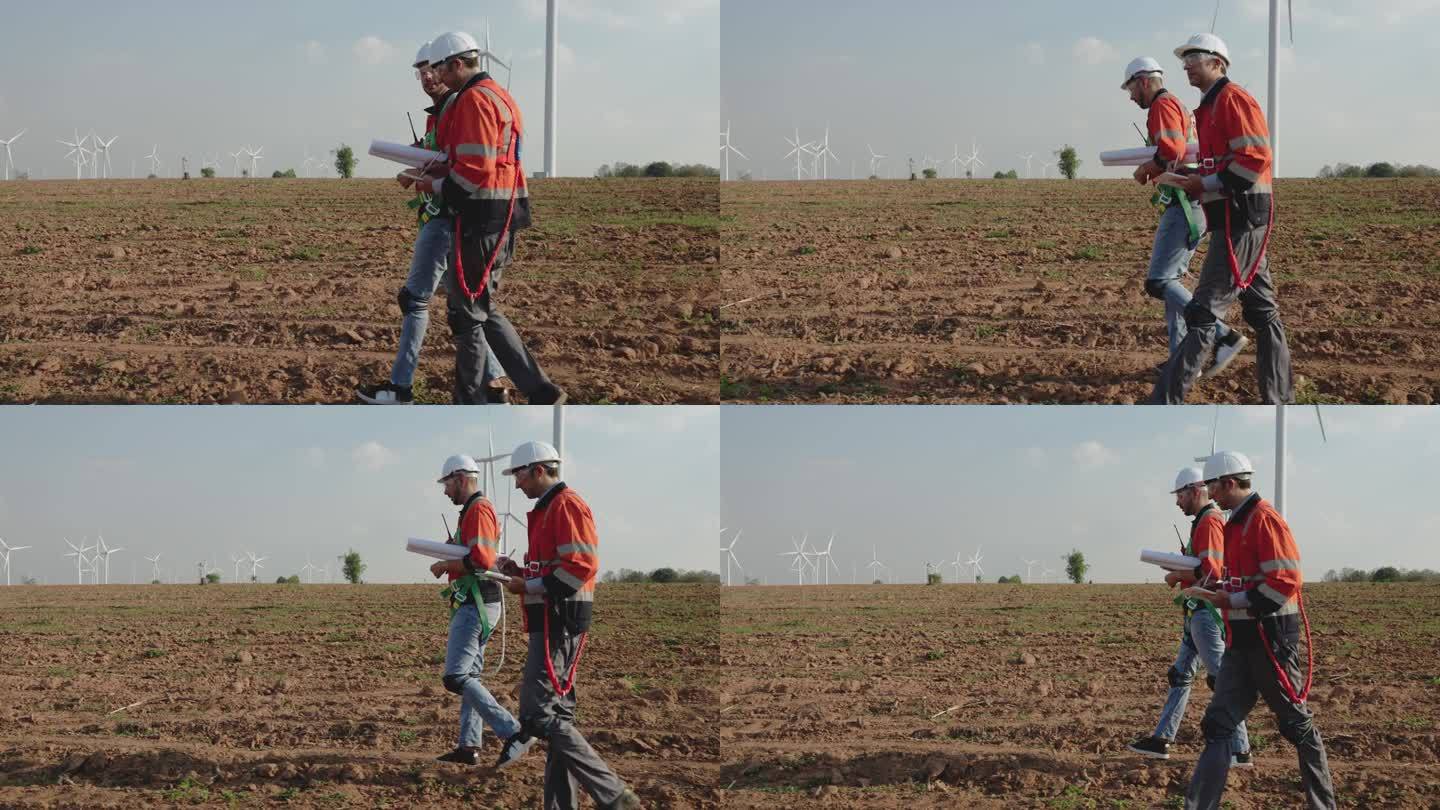 两位工程师正在检查风力涡轮机。