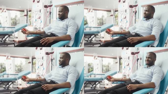 黑人企业家在光明医院为有需要的人献血。男性献血者挤压心形红球，将血液通过管道泵入袋中。为烧伤病人捐款