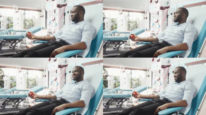 黑人商人在光明医院为需要的人献血。男性献血者挤压心形红球，将血液通过管道泵入袋中。为癌症患者捐款。